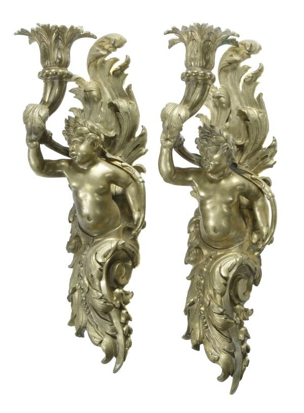 A pair of gilt metal cherub wall appliques, 19th
