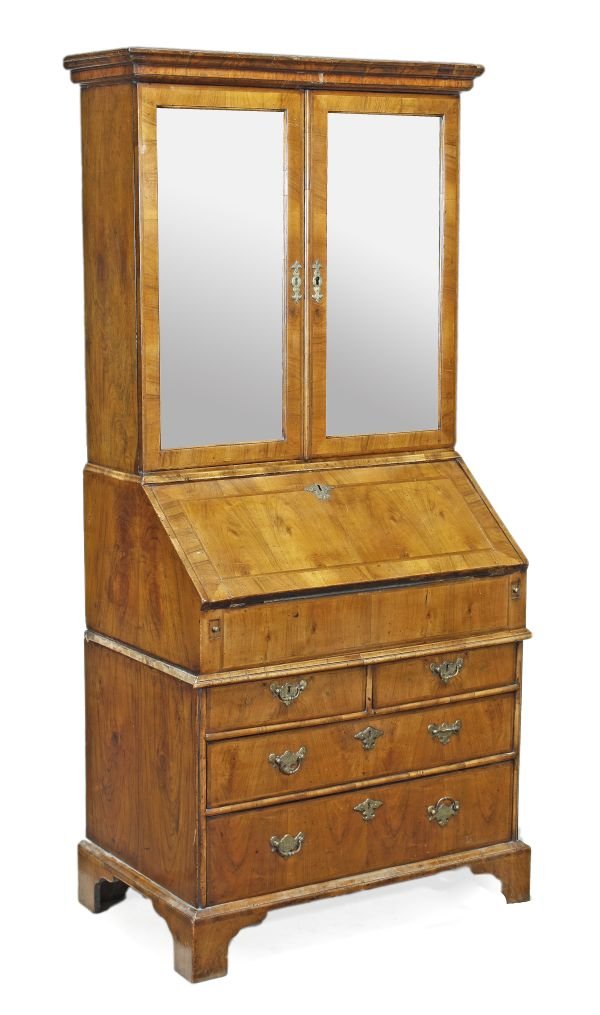 A George I walnut and featherbanded bureau bookcas