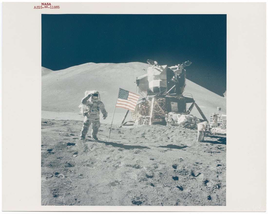 [Apollo 15] JAMES IRWIN SALUTES BESIDE THE U.S. FLAG, LUNAR MODULE AND THE FIRST LUNAR ROVER (1 of 3)