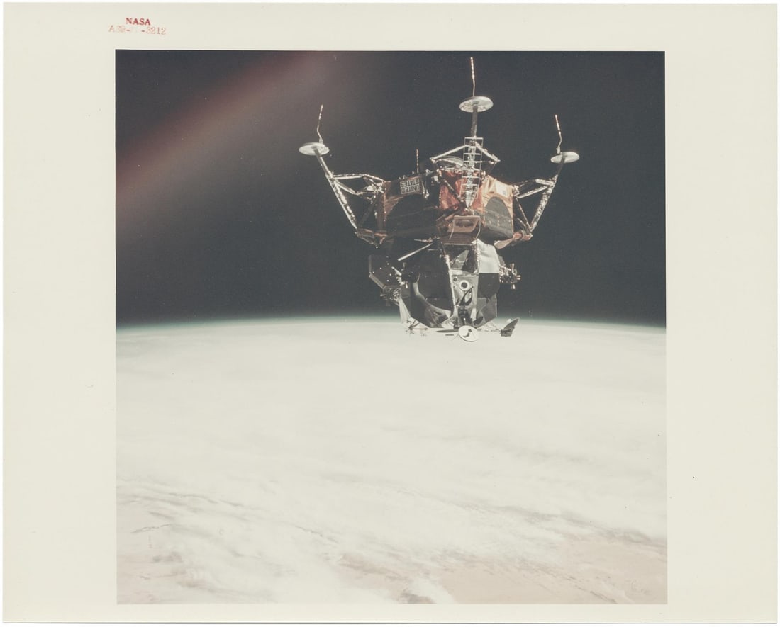 [Apollo 9] LM SPIDER FLOATS UPSIDE DOWN OVER EARTH DURING ITS MAIDEN FLIGHT (1 of 3)