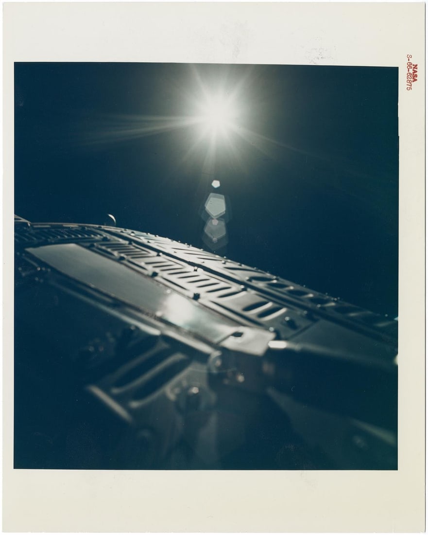 [Gemini XII] GEMINI SPACECRAFT BATHED IN SUNRISE DURING STAND-UP EVA (1 of 2)