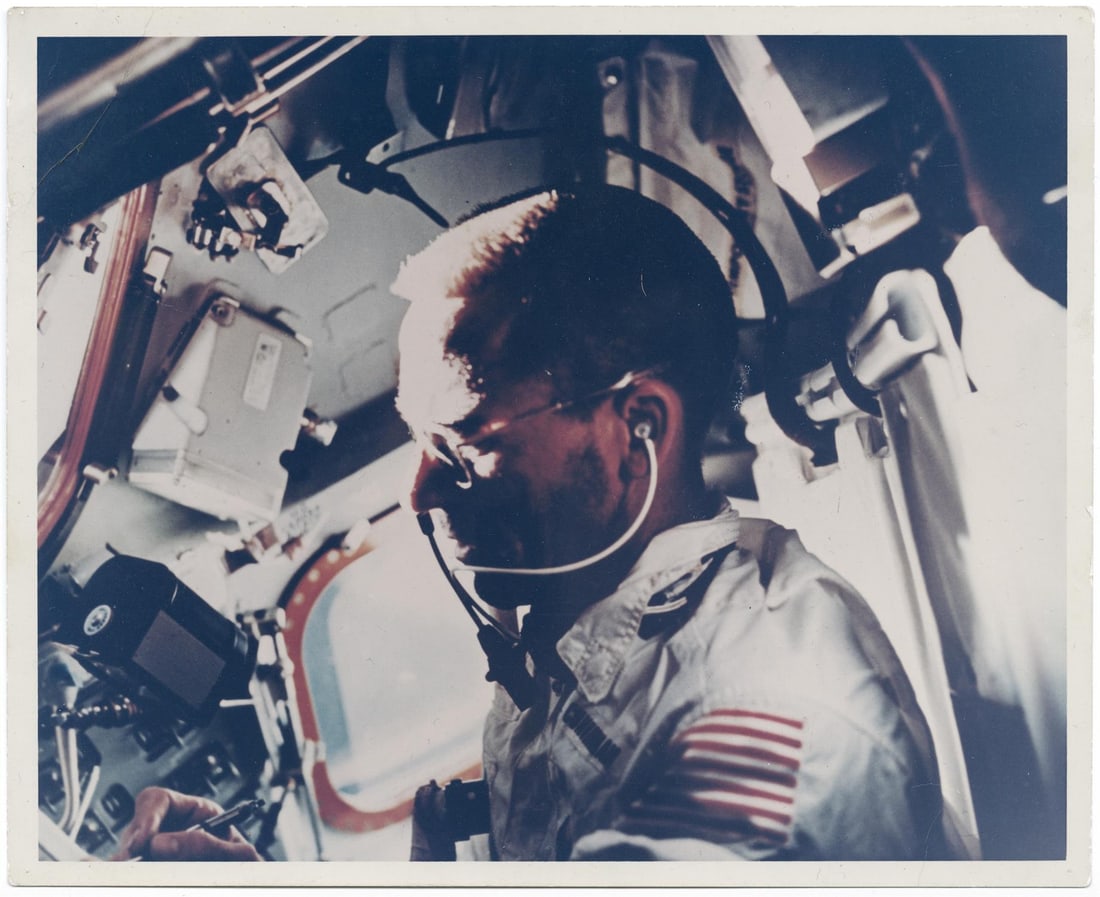 [Apollo 7] POTRAIT WALTER CUNNINGHAM IN MICROGRAVITY WITH FLOATING CAMERA MAGAZINE (1 of 3)