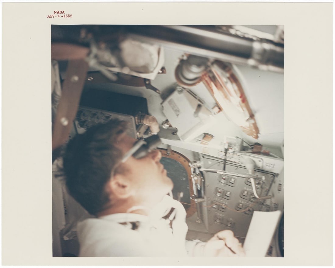 [Apollo 7] PORTRAIT OF WALTER SCHIRRA GAZING AT EARTH ABOARD THE FIRST APOLLO SPACECRAFT (1 of 2)