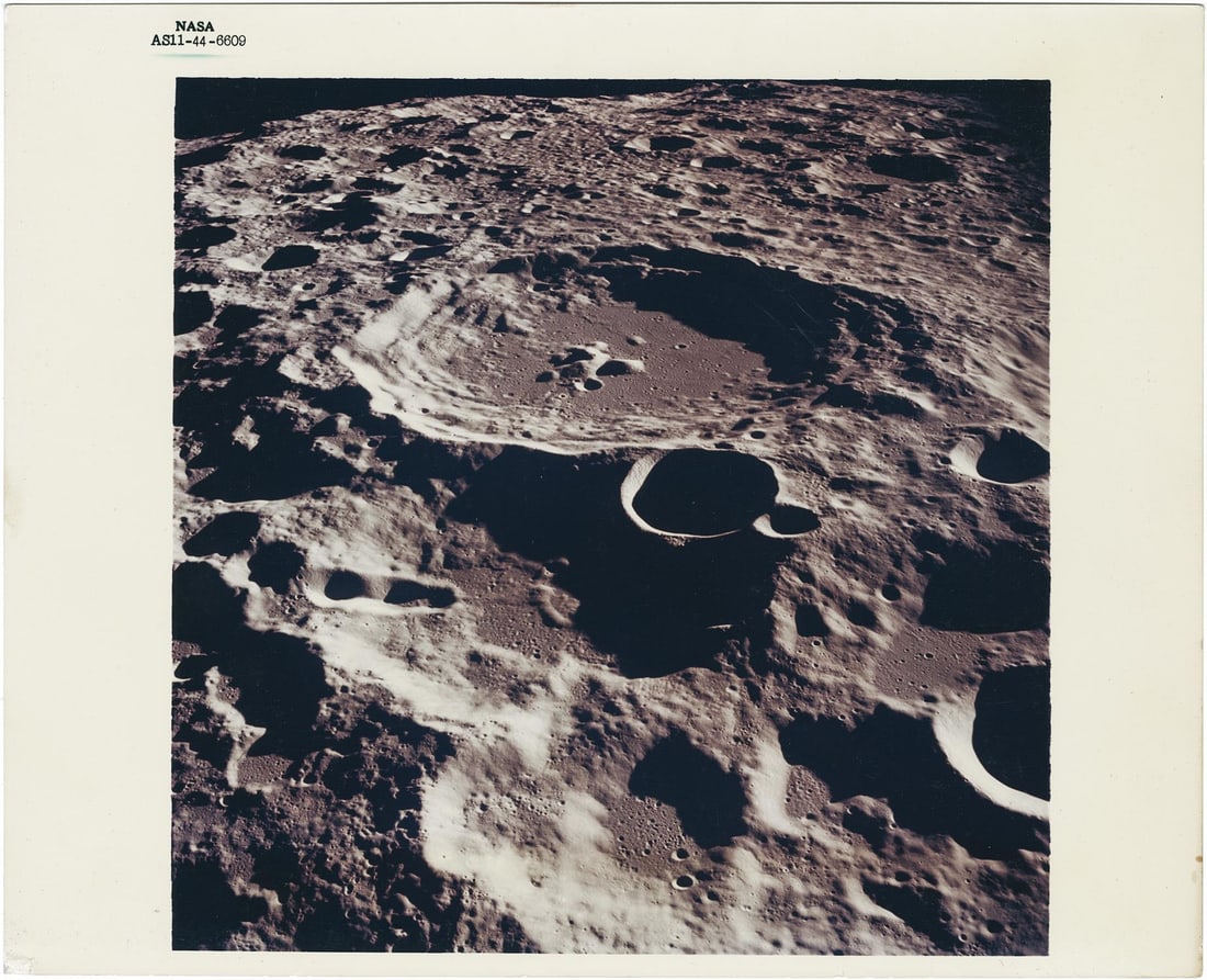 [Apollo 11] LUNAR FARSIDE: CRATER DAEDALUS AS SEEN BY MICHAEL COLLINS FROM ORBITTING COMMAND MODULE (1 of 2)