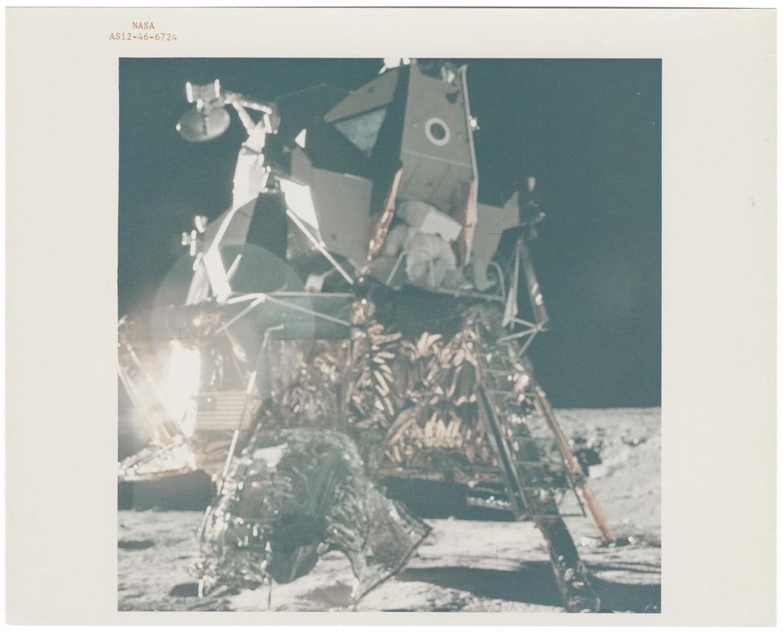 [Apollo 12] ALAN BEAN EMERGES FROM THE LUNAR MODULE TO TAKE HIS FIRST STEPS ON MOON (1 of 2)