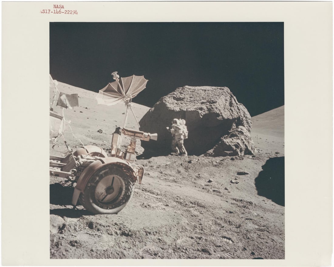 [Apollo 17] HARRISON SCHMITT TAKING PHOTOGRAPHS AT TRACY’S ROCK BEYOND THE ROVER, STATION 6 (1 of 3)
