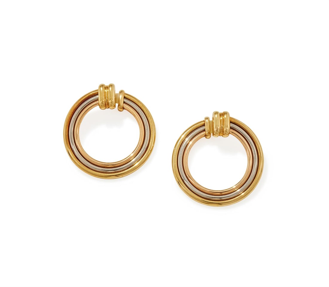 CARTIER, A PAIR OF 'TRINITY' HOOP EARRINGS: CARTIER, A PAIR OF 'TRINITY' HOOP EARRINGS Each of reeded tri-coloured flexible design, clip type fitting, signed Cartier, numbered 963528, stamped 750, Italian control marks, red maker's case and