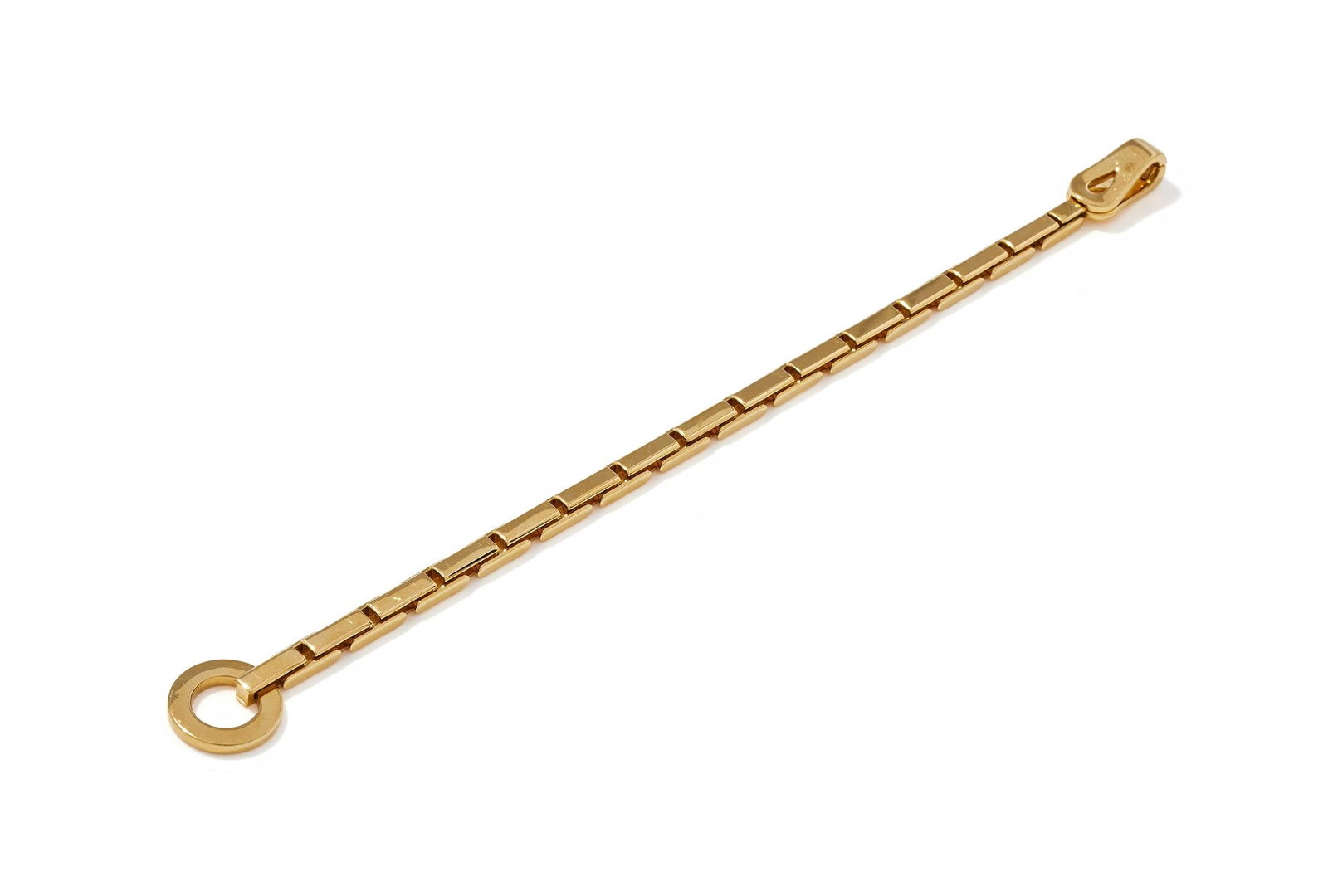 CARTIER, AN 'AGRAFE' BRACELET: CARTIER, AN 'AGRAFE' BRACELET The 18ct gold brick link bracelet to a hook and loop clasp, signed Cartier, numbered 873919, maker's mark, French poinçon, partial UK hallmark, common control mark,