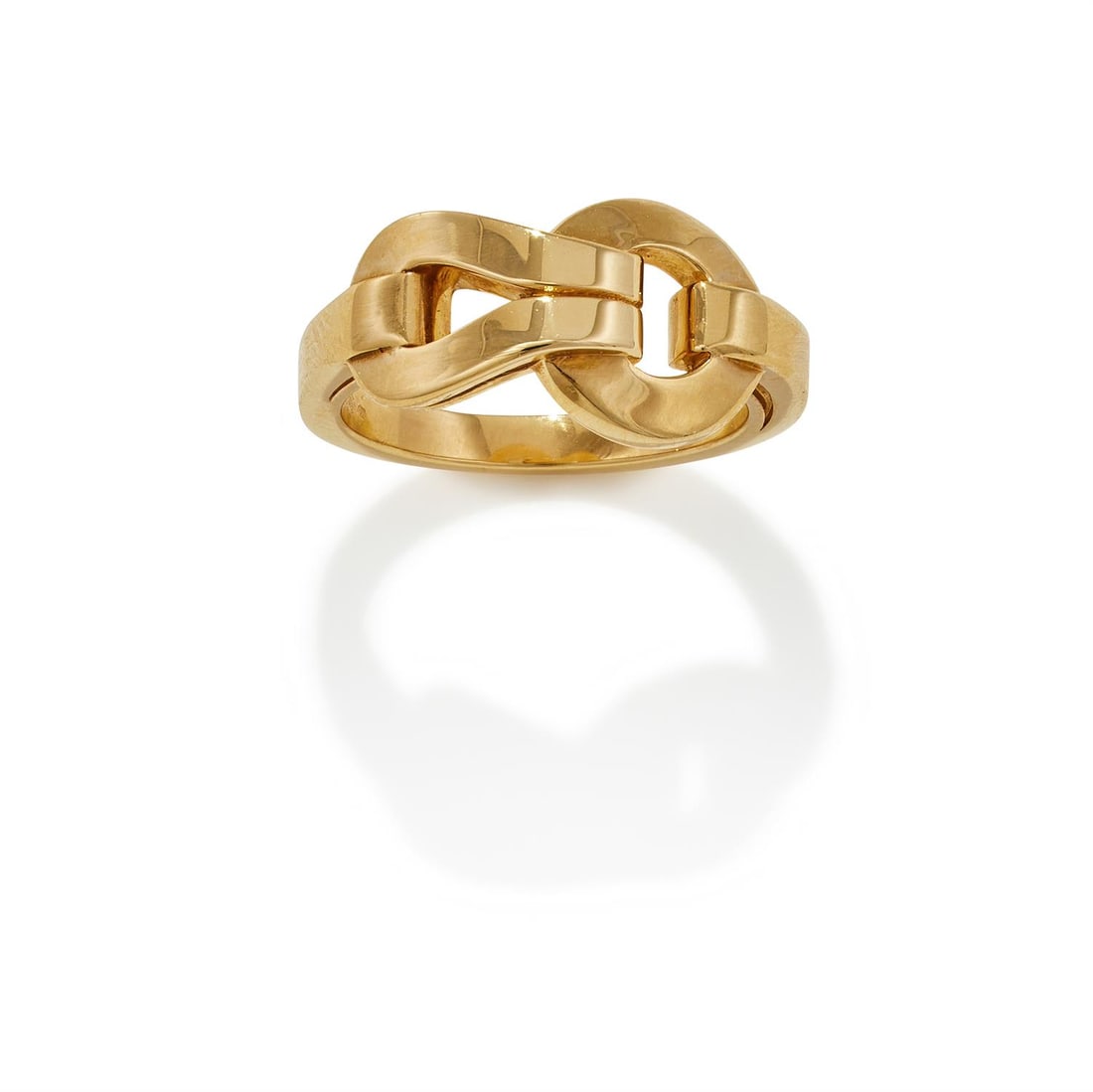 CARTIER, AN 18CT GOLD 'AGRAFE' RING: CARTIER, AN 18CT GOLD 'AGRAFE' RING Of loop and buckle design, to a polished band, signed Cartier, numbered GK1864, Swiss and common control marks, French poinçon and maker's mark, with red