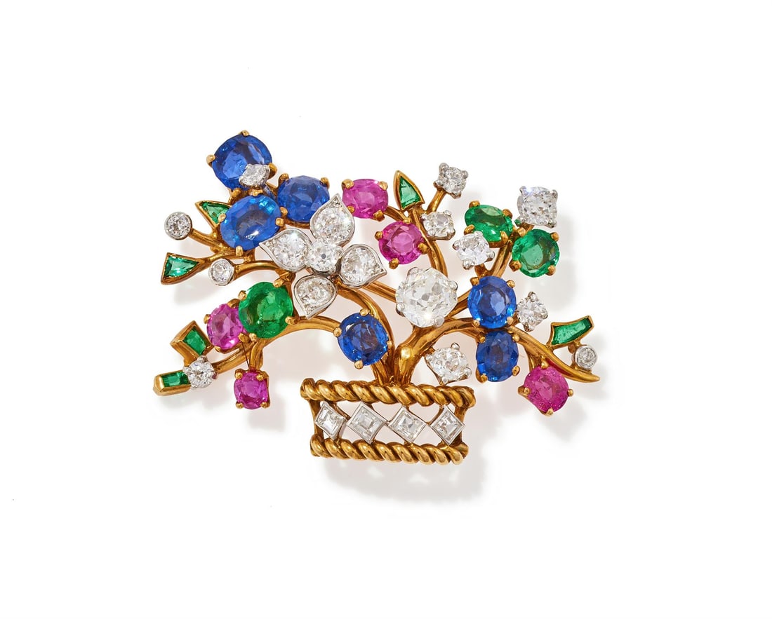 CARTIER, A MULTI GEM SET GIARDINETTO BROOCH: CARTIER, A MULTI GEM SET GIARDINETTO BROOCH The basket with ropetwist borders and step cut diamond detail, to polished gold branches set with oval cut sapphires, rubies, emeralds and old European cut