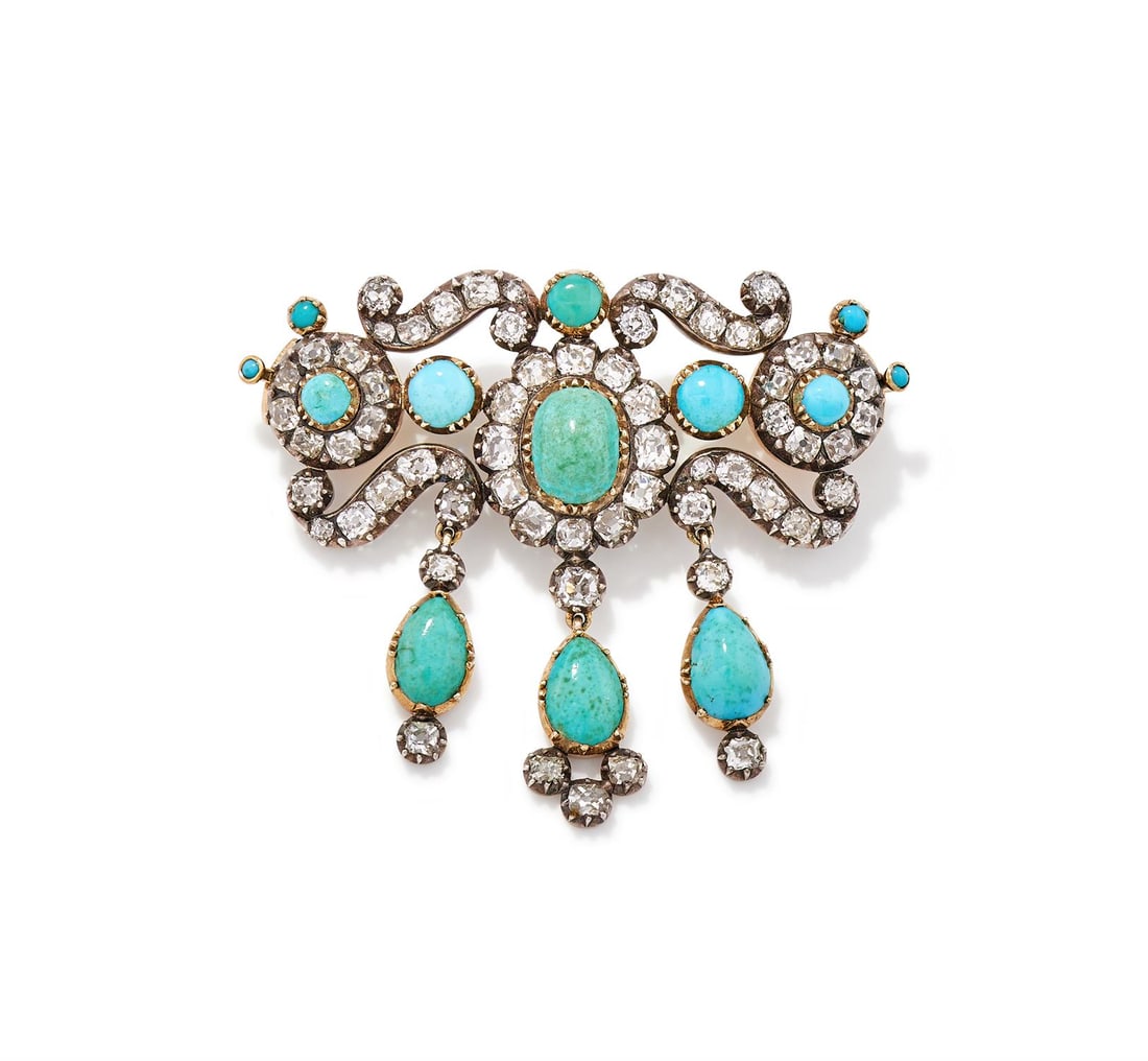 AN EARLY VICTORIAN DIAMOND AND TURQUOISE BROOCH CIRCA 1850: AN EARLY VICTORIAN DIAMOND AND TURQUOISE BROOCH CIRCA 1850 The three graduated old mine cut diamond and cabochon turquoise clusters joined by diamond set S-scrolls, suspending a trio of pear shaped