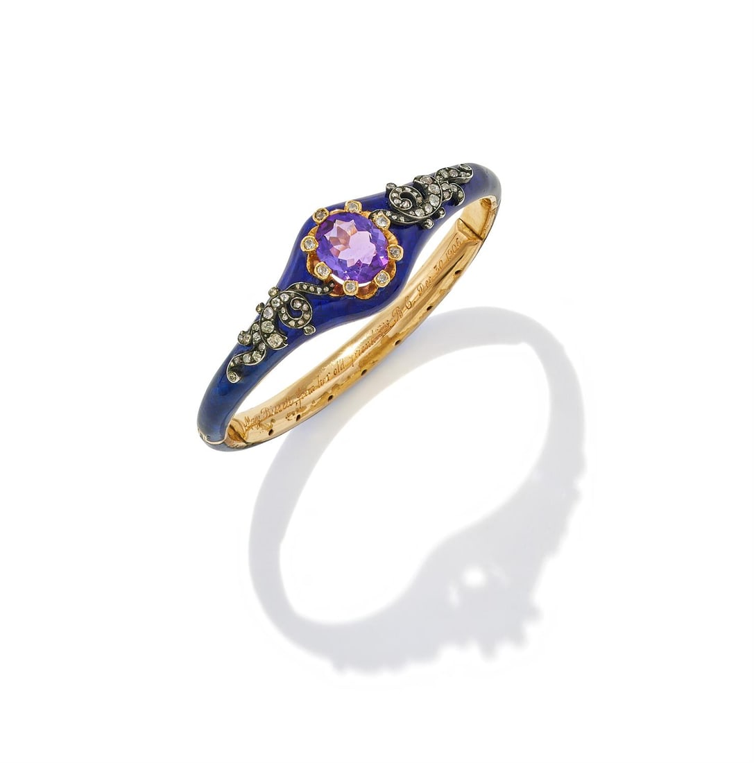 AN AMETHYST, DIAMOND AND ENAMEL BANGLE: AN AMETHYST, DIAMOND AND ENAMEL BANGLELATE 19TH CENTURY AND LATERThe blue guilloché enamel bangle with a central oval cut amethyst with old cut diamond set claws, between scrolled single and old