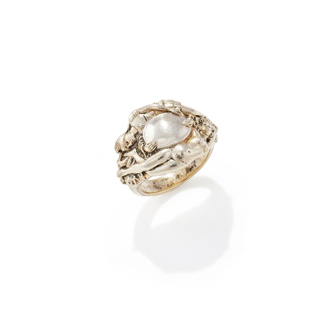 OMAR RAMSDEN, A SILVER DRESS RING: OMAR RAMSDEN, A SILVER DRESS RINGDesigned as a soldier and a nymph holding a shield, inscribed 'Omar Ramsden Me Fecit, Given by Leslie Durbin', unmarkedSize/dimensions: ring size QGross weight: 18.1 g