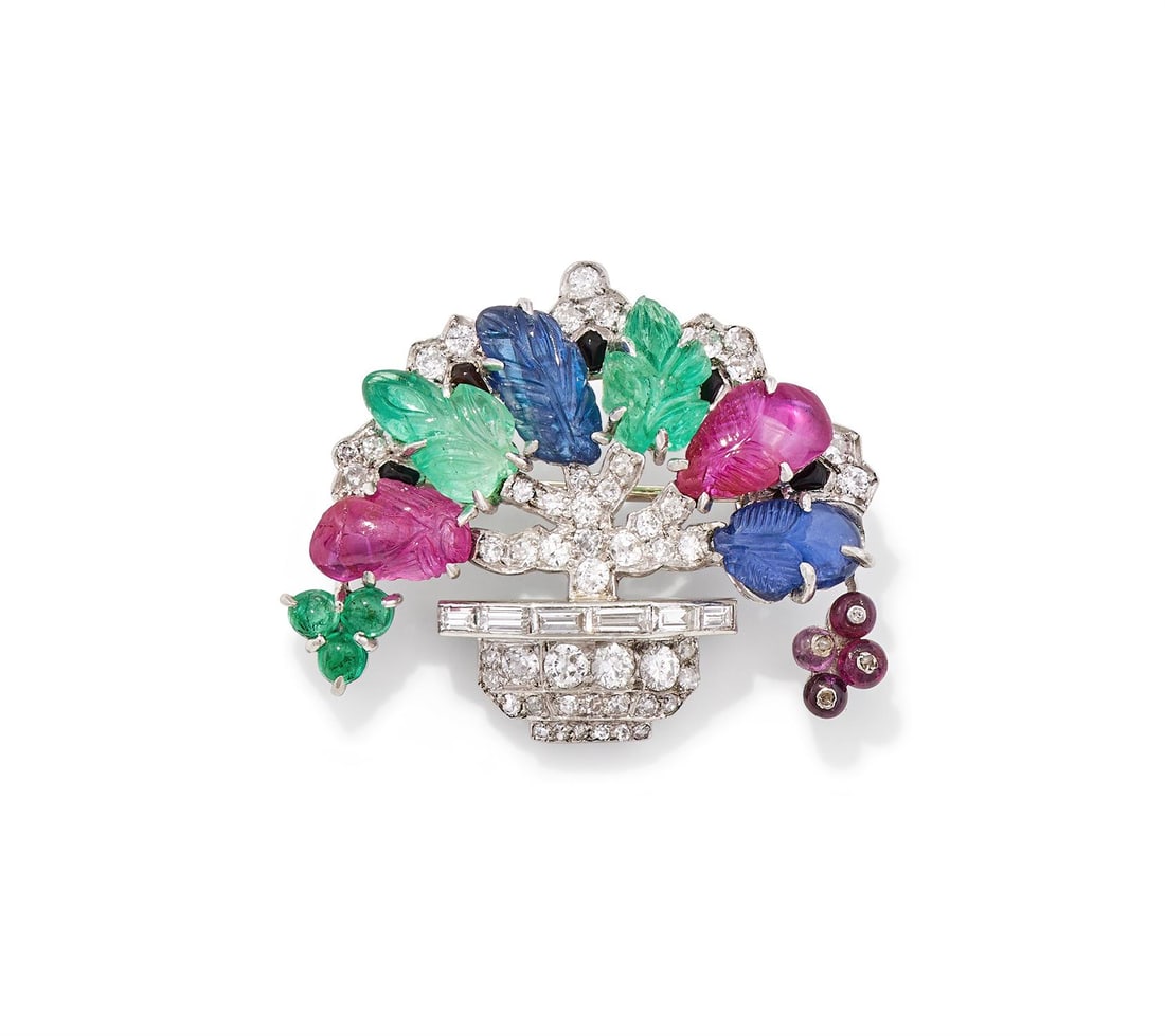 A MID 20TH CENTURY GEM SET GIARDINETTO BROOCH: A MID 20TH CENTURY GEM SET GIARDINETTO BROOCHIn the 'Tutti Frutti' style, the circular cut diamond set basket with baguette cut diamond rim, issuing diamond set branches terminating in carved ruby, sa