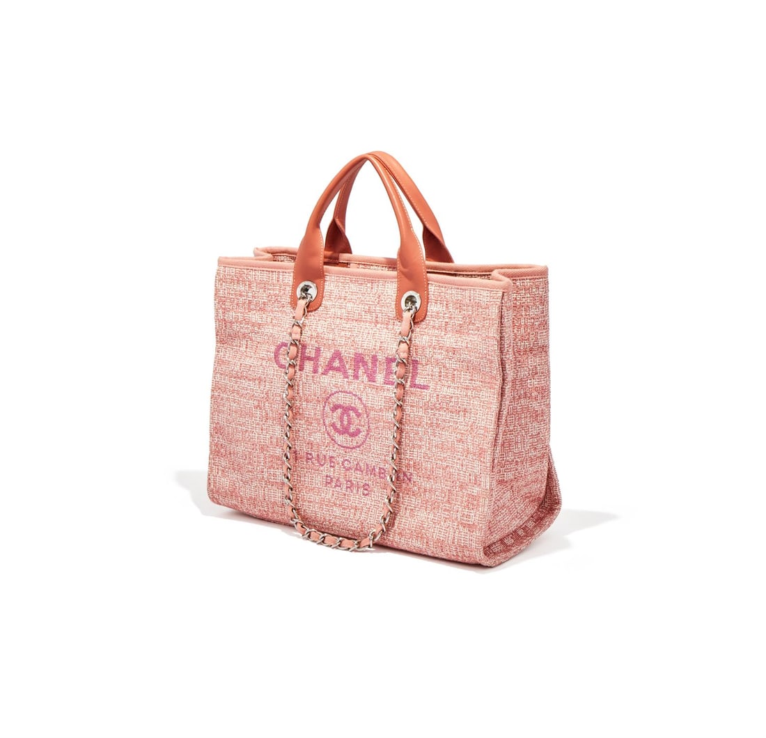 CHANEL, DEAUVILLE, A PINK FABRIC TOTE: CHANEL, DEAUVILLEA PINK FABRIC TOTE, NO. 29393841With a white metal and pink fabric entwined shoulder strap and twin leather loop handles, the pop button fastener opening to a pink interior with a zip