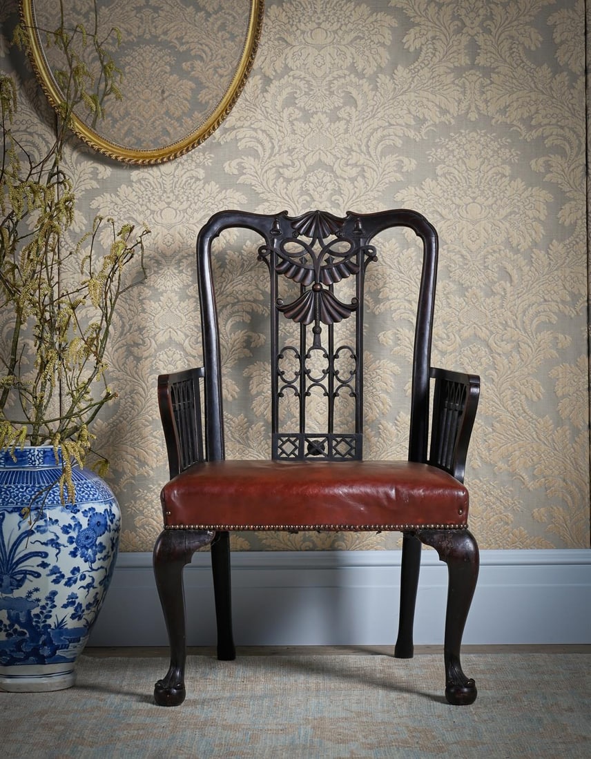 AN UNUSUAL GEORGE III CARVED MAHOGANY AND LEATHER UPHOLSTERED OPEN ARMCHAIR, CIRCA 1760 (1 of 5)