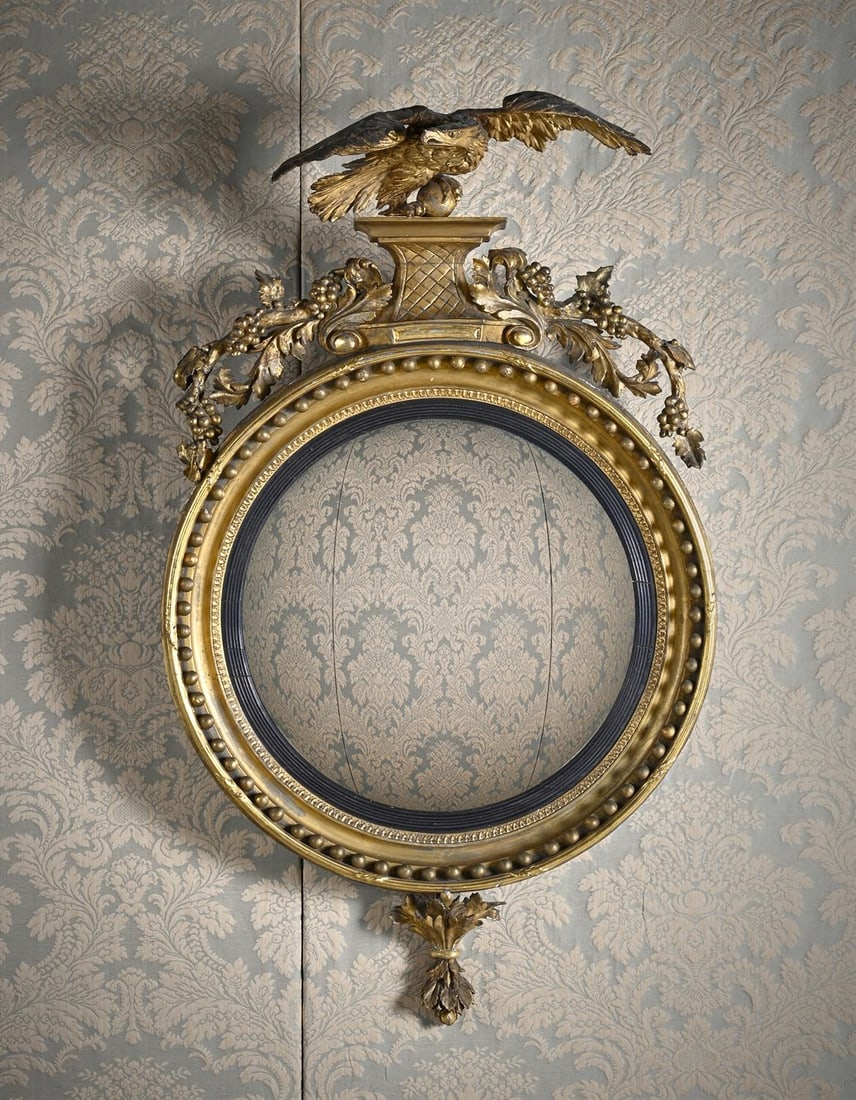 A LARGE REGENCY CARVED GILTWOOD AND GESSO CONVEX WALL MIRROR, IN THE MANNER OF THOMAS FENTHAM (1 of 4)
