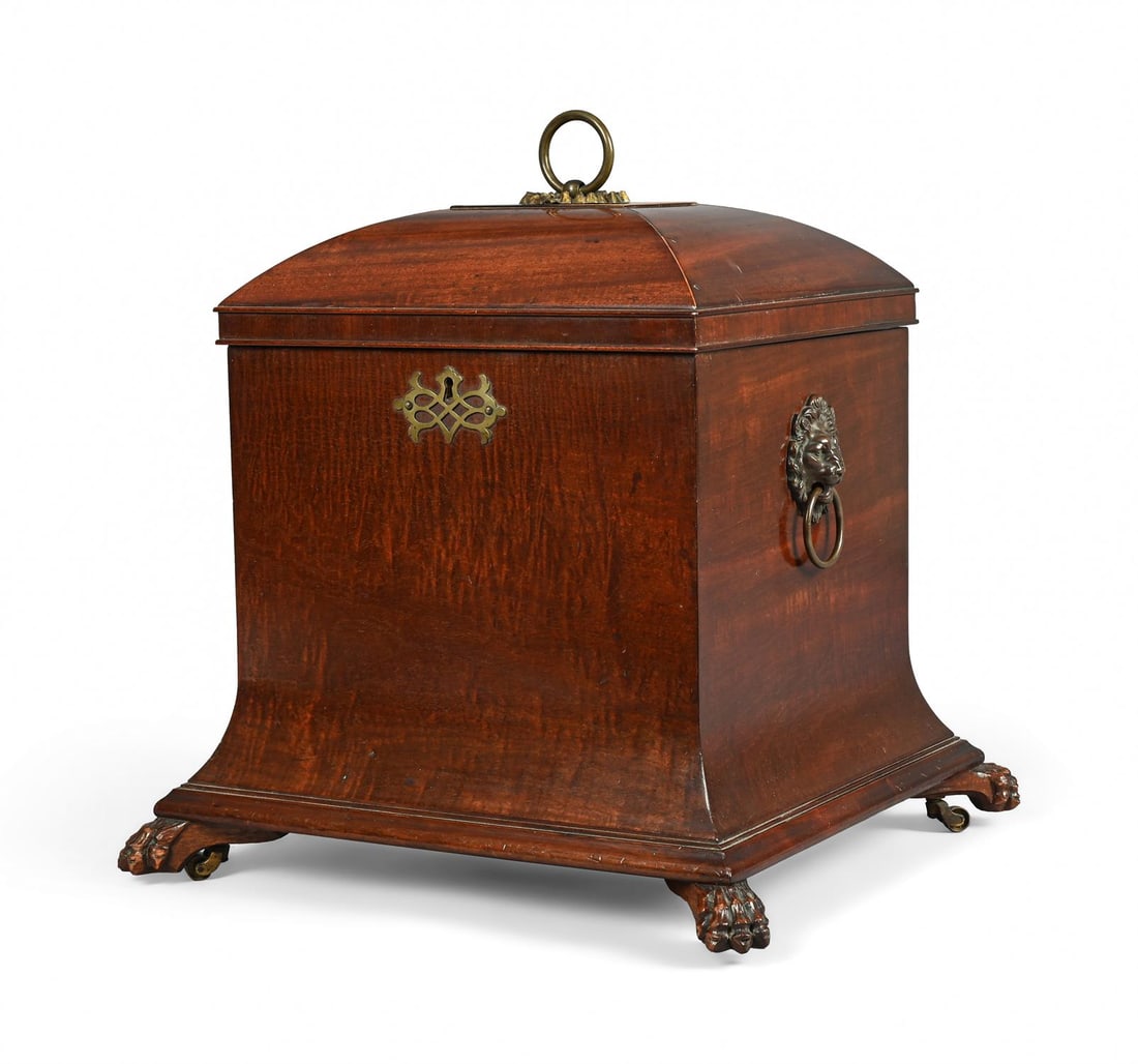 AN UNUSUAL REGENCY MAHOGANY CELLARET, EARLY 19TH CENTURY: AN UNUSUAL REGENCY MAHOGANY CELLARETEARLY 19TH CENTURYThe hinged lid enclosing four baize lined divisions, the carved paw feet with recessed brass casters46cm high, 50cm wide, 46cm deep