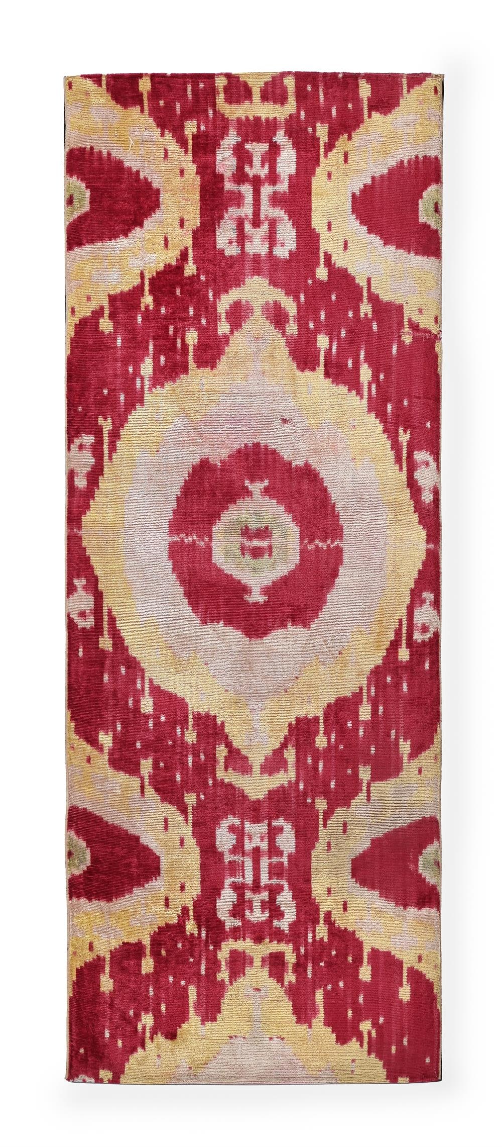 A VELVET IKAT PANEL: A VELVET IKAT PANEL Lined and mounted onto a stretcher frame107 x 39cm