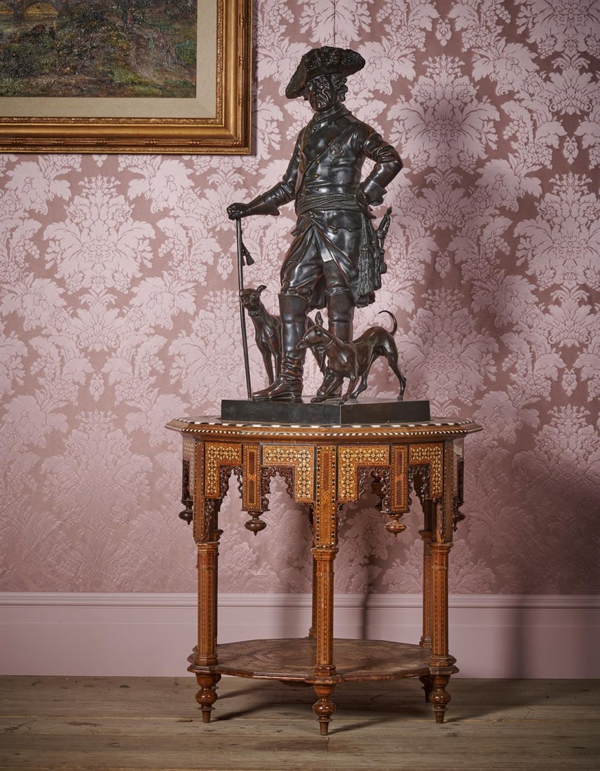 AFTER JOHANN GOTTFRIED SCHADOW (1764-1850), A LARGE BRONZE FIGURE OF FREDERICK II OF PRUSSIA: AFTER JOHANN GOTTFRIED SCHADOW (1764-1850), A LARGE BRONZE FIGURE OF FREDERICK II OF PRUSSIA (1712-1786) NOACK FOUNDRY, EARLY 20TH CENTURY The king depicted out walking with his dogs, collars inscribe