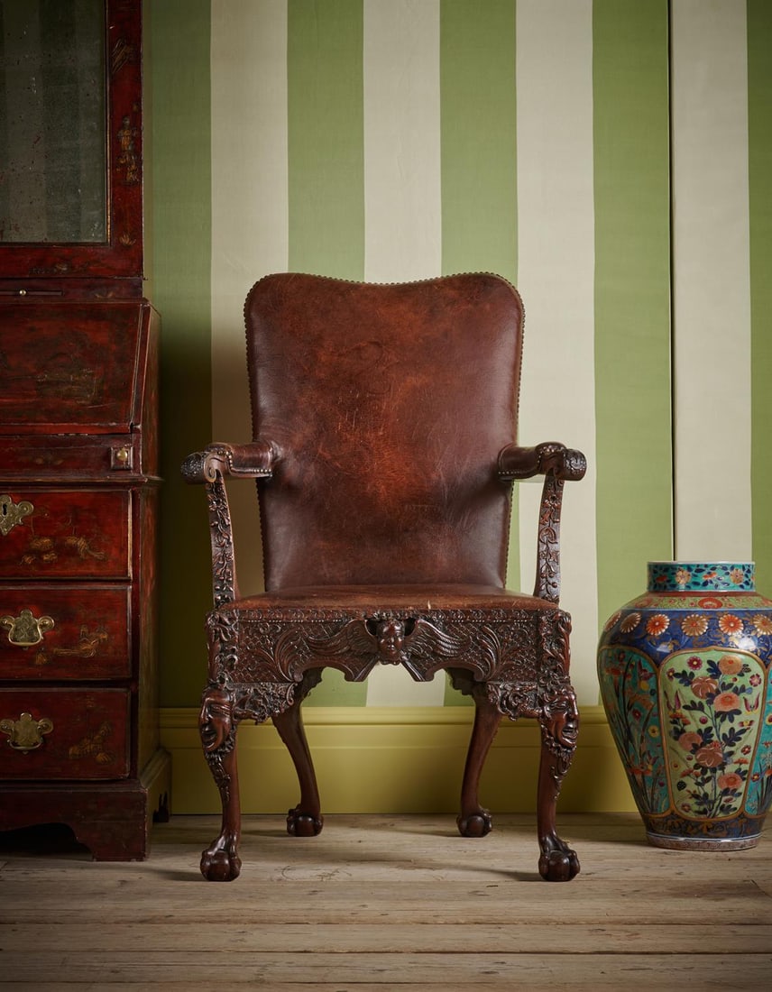 AN UNUSUAL GEORGE II CARVED MAHOGANY AND LEATHER UPHOLSTERED LIBRARY ARMCHAIR, PROBABLY IRISH (1 of 4)