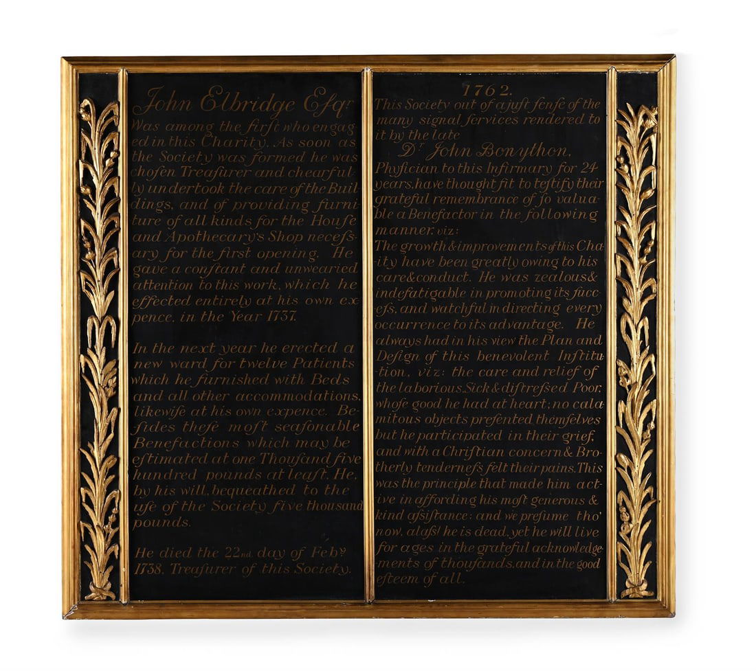 A GEORGE III CARVED GILTWOOD AND EBONISED MEMORIAL BOARD, DATE 1762: A GEORGE III CARVED GILTWOOD AND EBONISED MEMORIAL BOARDDATE 1762The ebonised panels with cursive script for John Elbridge Esq'r134.5cm high, 144cm wideJohn Elbridge (1672 - 1739) in 1708 succeeded hi