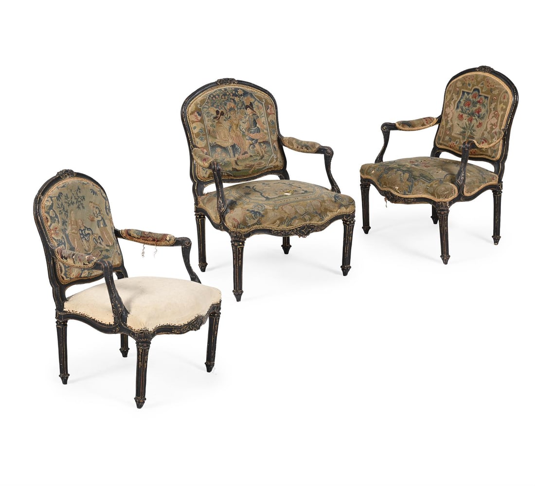 A SET OF THREE LOUIS XVI EBONISED AND PARCEL GILT FAUTEUILS, LATE 18TH CENTURY: A SET OF THREE LOUIS XVI EBONISED AND PARCEL GILT FAUTEUILS LATE 18TH CENTURYEach with needlework upholstery, the dust cover marked for Touzan Tapissier90cm high, 68cm wide, 55cm deep