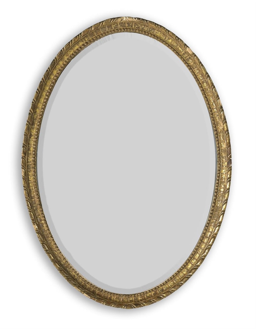 A GEORGE III CARVED GILTWOOD OVAL MIRROR, CIRCA 1780 (1 of 2)