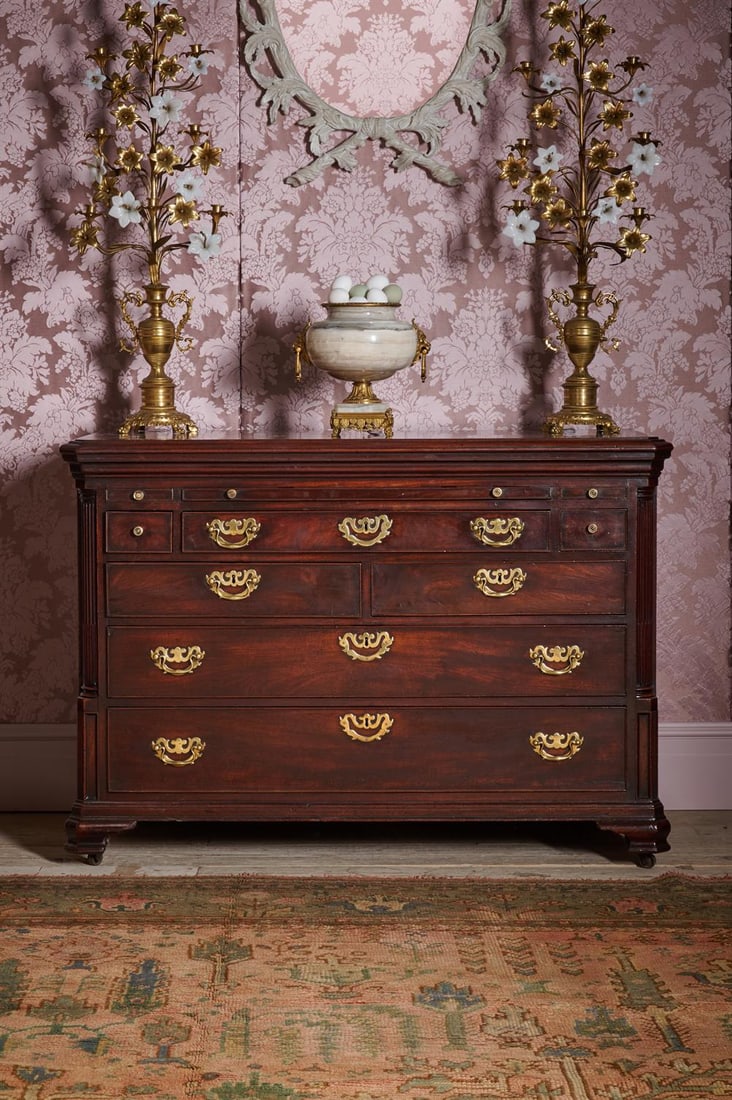 A GEORGE III MAHOGANY CHEST OF DRAWERS, ATTRIBUTED TO GILLOWS, CIRCA 1780: A GEORGE III MAHOGANY CHEST OF DRAWERSATTRIBUTED TO GILLOWS, CIRCA 1780With a ratchet adjustable baize writing slope above a fitted drawer containing a slide and storage94cm high, 135cm wide, 63cm dee