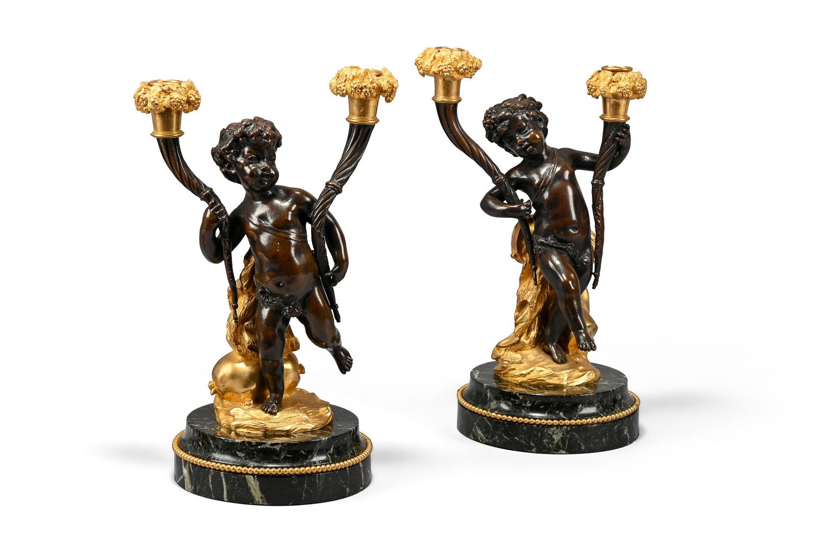 A PAIR OF FRENCH GILT AND PATINATED BRONZE CHERUB BASE CANDLESTICKS, IN THE MANNER OF CLODION (1 of 3)