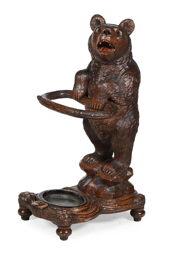 A BLACK FOREST CARVED BEECH STICK STAND, LATE 19TH OR EARLY 20TH CENTURY (1 of 3)