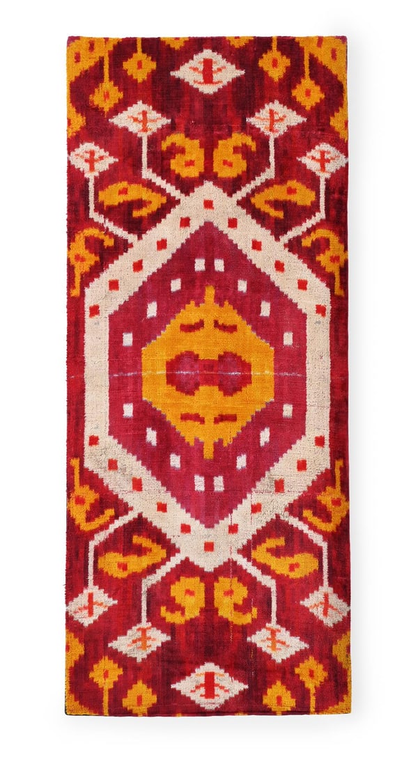 A VELVET IKAT PANEL: A VELVET IKAT PANEL Lined and mounted onto a stretcher frame77 x 32cm