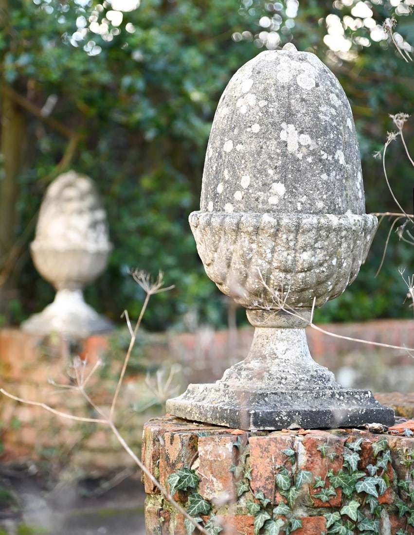 A PAIR OF COMPOSITION STONE ACORN GATEPOST FINIALS, 20TH CENTURY: A PAIR OF COMPOSITION STONE ACORN GATEPOST FINIALS 20TH CENTURY 67cm high, base 29cm square