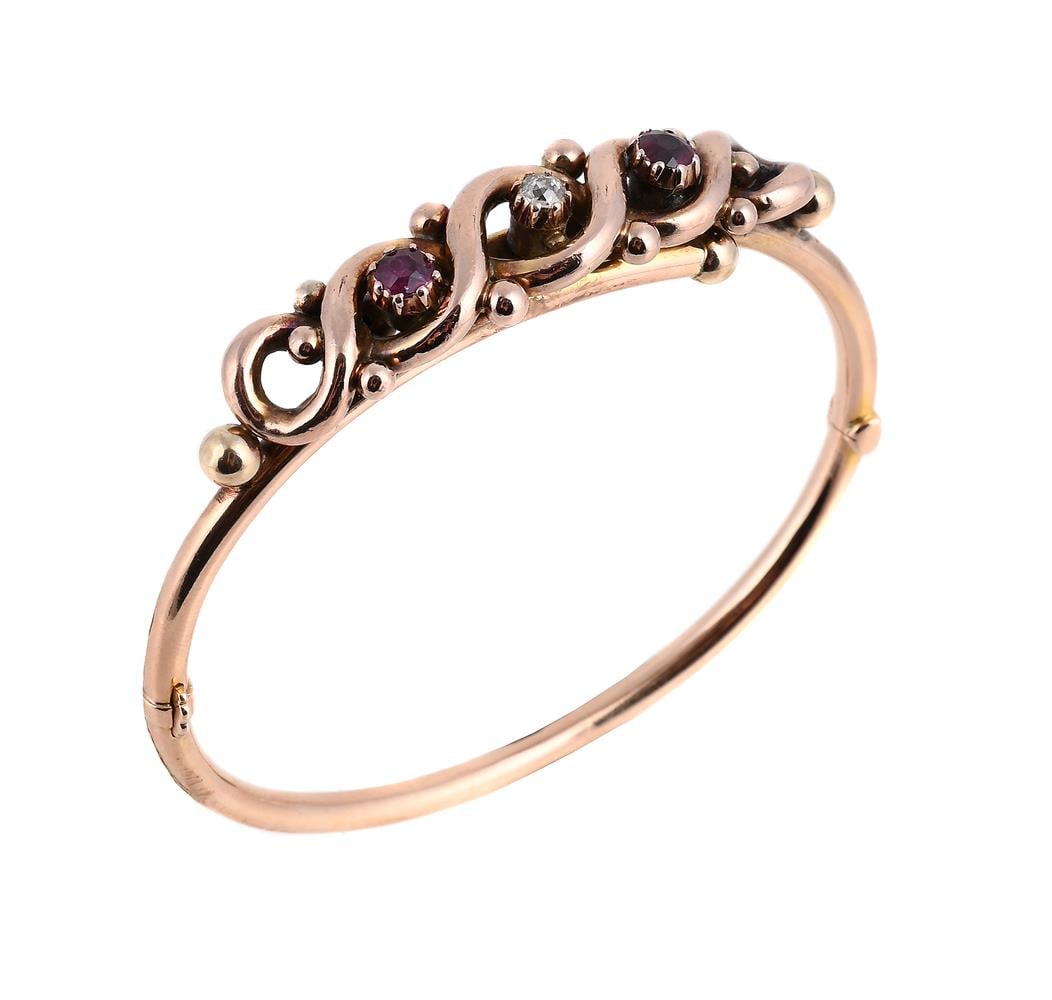 A LATE VICTORIAN RUBY AND DIAMOND HINGED BANGLE (1 of 2)