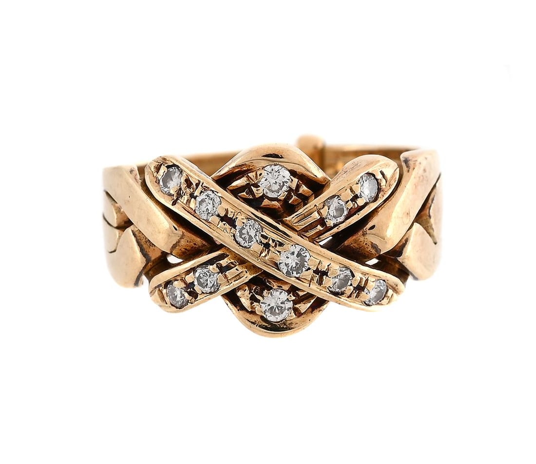 A DIAMOND PUZZLE RING: A DIAMOND PUZZLE RING The interlocking panels making a knot motif set with brilliant cut diamonds, unmarked Size/dimensions: ring size K 1/2 Gross weight: 4.7 grams 