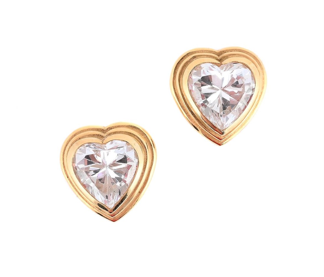 A PAIR OF WHITE STONE EARRINGS: A PAIR OF WHITE STONE EARRINGS The heart shaped white stones within polished collet settings, the stud fittings stamped 750 Size/dimensions: 1.2cm long Gross weight: 4.9 grams 
