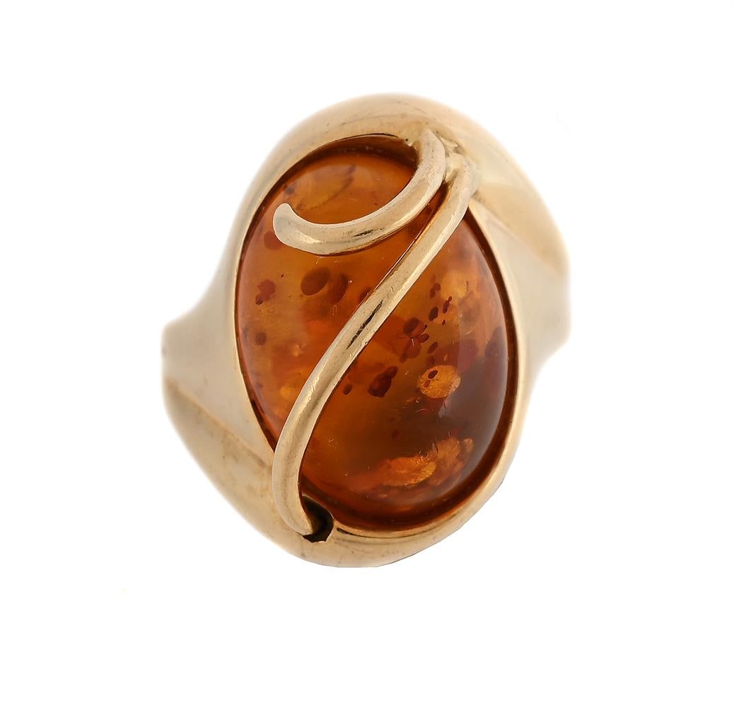 AN AMBER DRESS RING: AN AMBER DRESS RING The oval clarified