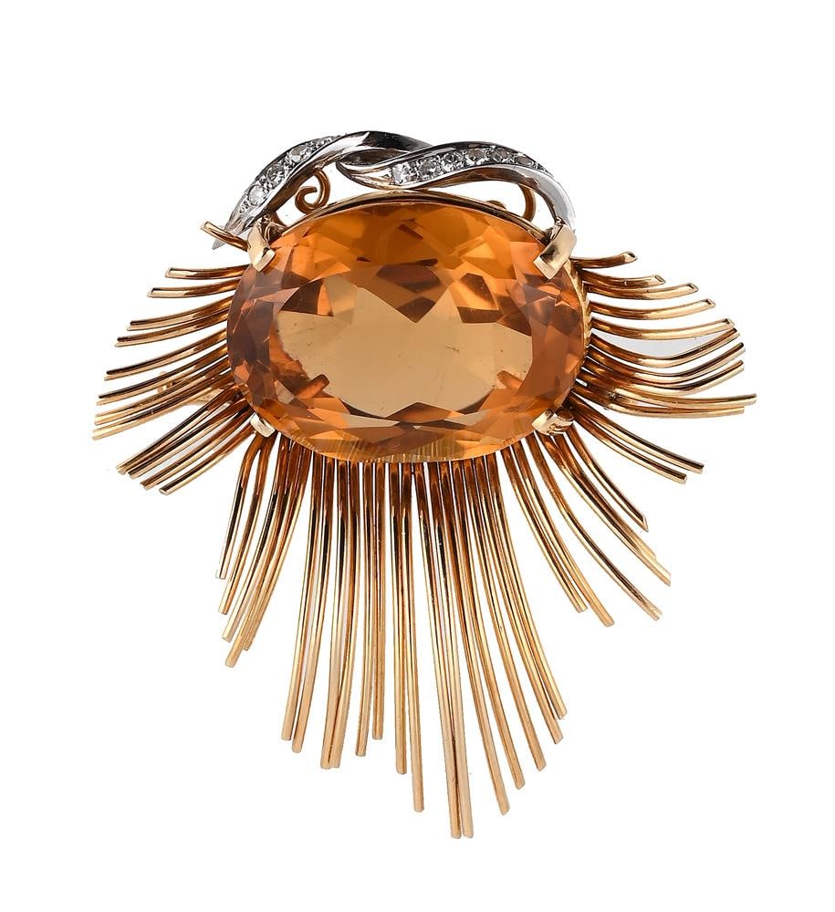 A CITRINE AND DIAMOND ABSTRACT BROOCH: A CITRINE AND DIAMOND ABSTRACT BROOCH The oval cut citrine with a single cut diamond pediment, with a radiating surround of polished bars, stamped 18K and PL Size/dimensions: 5.2cm