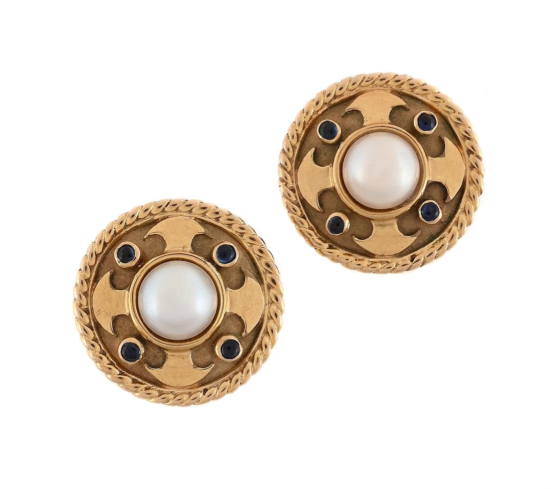 A PAIR OF SAPPHIRE AND CULTURED PEARL EARRINGS: A PAIR OF SAPPHIRE AND CULTURED PEARL EARRINGS The 9ct gold circular panels with central cultured pearls, each with four cabochon sapphires interspaced by polished motifs, ropetwist