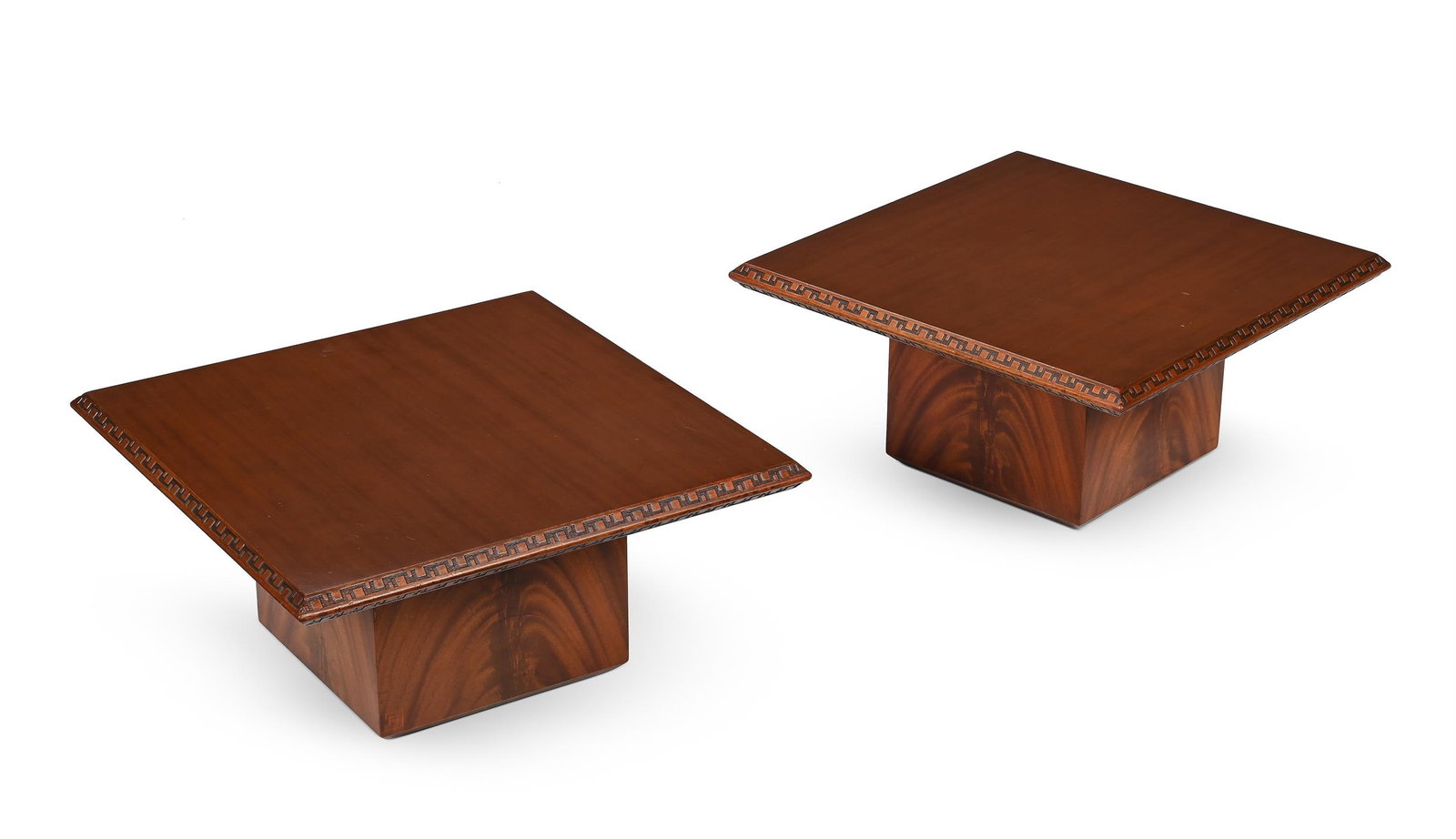 FRANK LLOYD WRIGHT (AMERICAN, 1867–1959), A PAIR OF 'TALIESIN' COFFEE TABLES, DESIGNED IN 1955: FRANK LLOYD WRIGHT (AMERICAN, 1867-1959)A PAIR OF 'TALIESIN' COFFEE TABLES, DESIGNED IN 1955Mahogany, with a stylised 'Greek-key' borderUnderside stamped with 'Heritage Henreden by Frank Lloyd Wright'