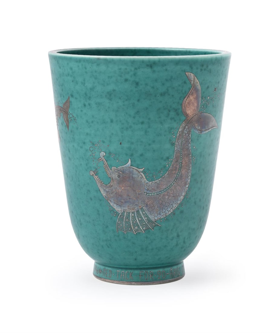 WILHELM KÅGE (1889-1960), FOR GUSTAVSBERG, AN 'ARGENTA' VASE WITH FISH, 1946: WILHELM KÅGE (1889-1960) FOR GUSTAVSBERGAN 'ARGENTA' VASE WITH FISH, 1946Aqua glazed pottery, decorated with silver appliqué fish; the foot as an inscription 'MED TACK FOR 20 ARIS GÄRNI