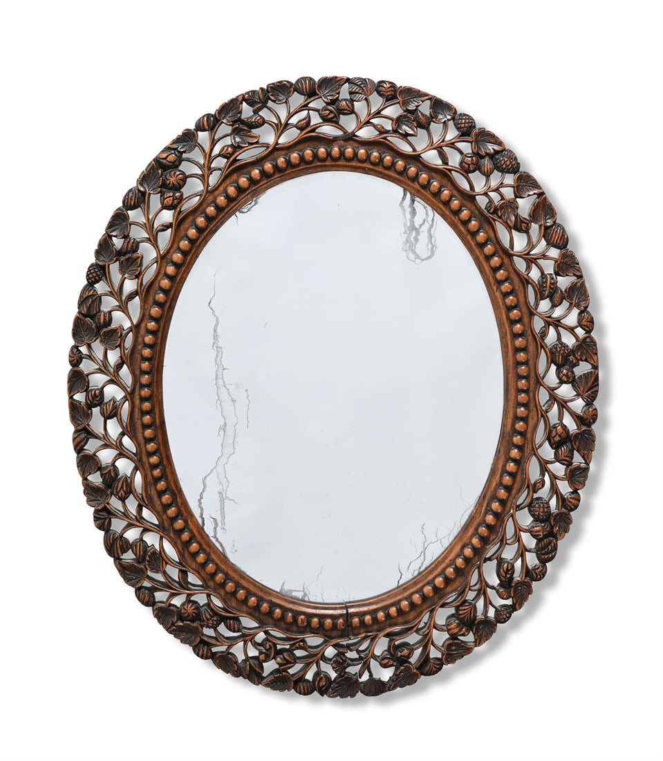 A SWEDISH GRACE OVAL MIRROR, 20TH CENTURY: SWEDISH GRACEAN OVAL MIRROR, 20TH CENTURYCarved wood frame with beaded border and stylised openwork foliage55cm x 47.5cm
