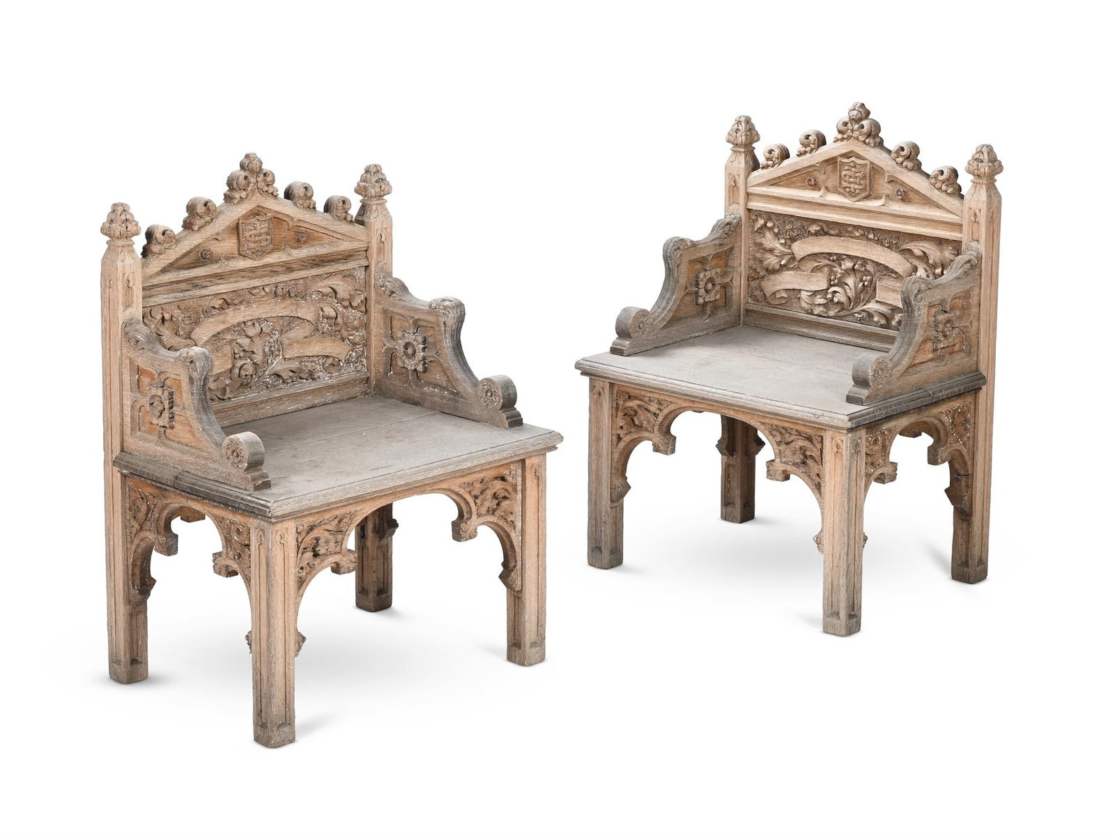 A PAIR OF GOTHIC STYLE CARVED CHAIRS, 20TH CENTURY: GOTHIC STYLEA PAIR OF CARVED CHAIRS, 20TH CENTURYLimed oak 80.5cm high, 57.5cm wide, 42.5cm deep