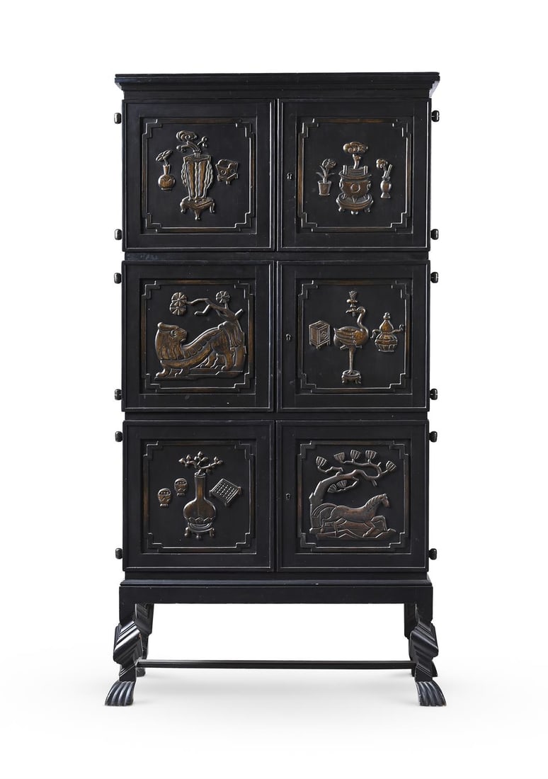 OTTO SCHULZ (GERMAN, 1882-1970), SWEDISH GRACE CABINET; CIRCA 1930: OTTO SCHULZ (GERMAN, 1882-1970)A 'SWEDISH GRACE' CABINET; CIRCA 1930Dark stained wood (likely birch), with painted gilded highlights to the six relief panels, the interior with six abstract painted po