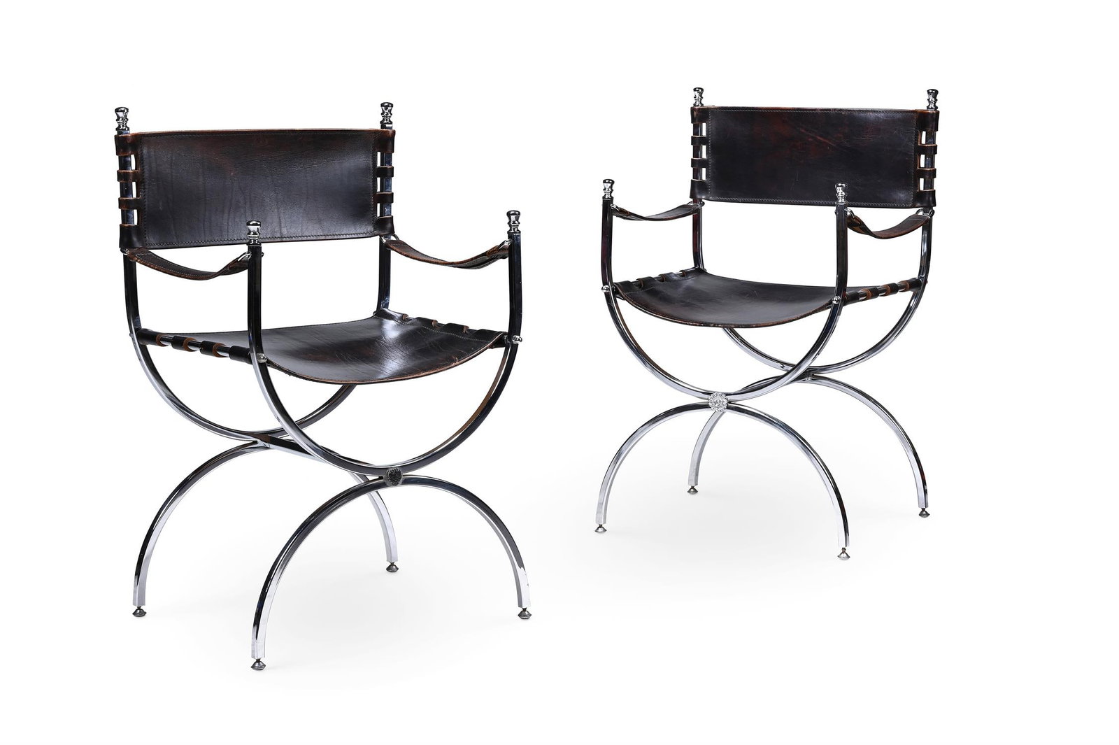 MAISON JANSEN (FRENCH) ATTRIBUTED, PAIR OF 'SAVONAROLA' ARMCHAIRS; SECOND HALF 20TH CENTURY: MAISON JANSEN (FRENCH) ATTRIBUTEDPAIR OF 'SAVONAROLA' ARMCHAIRS; SECOND HALF 20TH CENTURYLeather, polished chrome; X frame form with finial details to arm and back88.5cm high, 52.5cm wide, 44cm deepPr