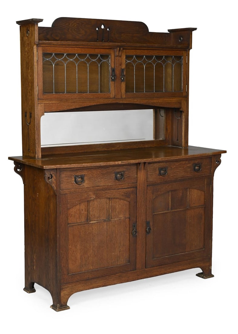 ARTS AND CRAFTS DRESSER; CIRCA 1890: ARTS AND CRAFTSDRESSER; CIRCA 1890Oak with carved details, copper locks and handles, leaded glass189cm high, 153cm wide, 57cm deep