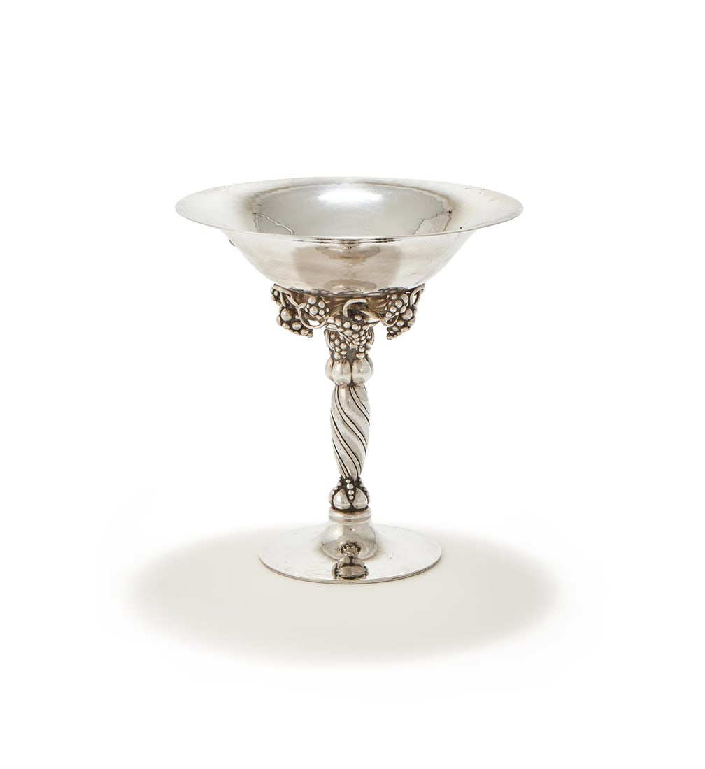 GEORG JENSEN (DANISH, 1866-1935), A PEDESTAL BOWL, MODEL NO. 263; 1915-1927: GEORG JENSEN (DANISH, 1866-1935)A PEDESTAL BOWL, MODEL NO. 263; 1915-1927 Silver, with a hammered finish, grape vine decoration, wrythen stem and circular pedestal foot. Engraved beneath foot 'J.T.Mc.