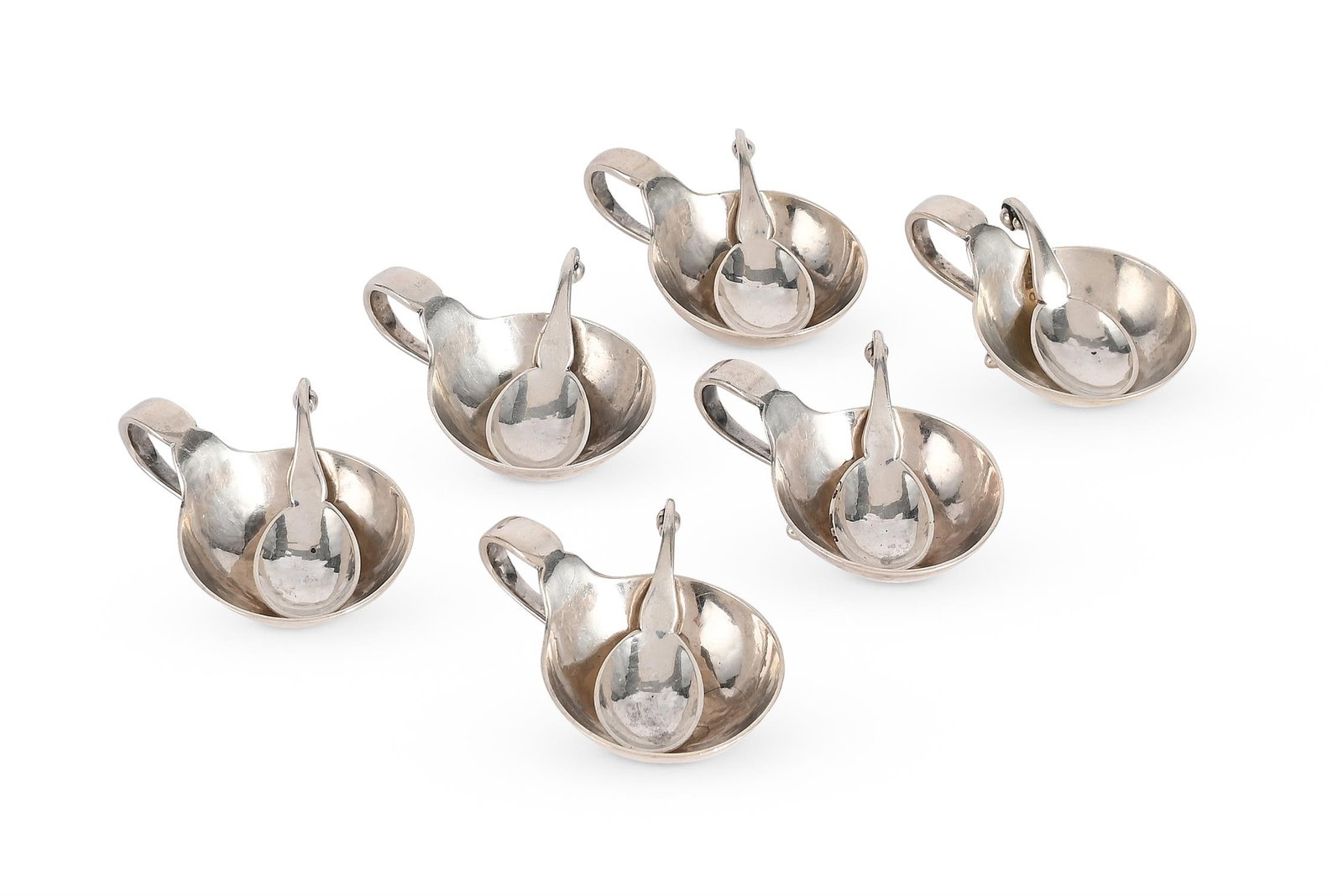 GEORG JENSEN (DANISH, 1866-1935), SIX OPEN SALTS AND SPOONS; MODEL 110; CIRCA 1925: GEORG JENSEN (DANISH, 1866-1935)SIX OPEN SALTS AND SPOONS; MODEL 110; CIRCA 1925Silver; hammered finish to open salts, scrolling handles, raised on two ball feetTogether with Georg Jensen gift box. Im