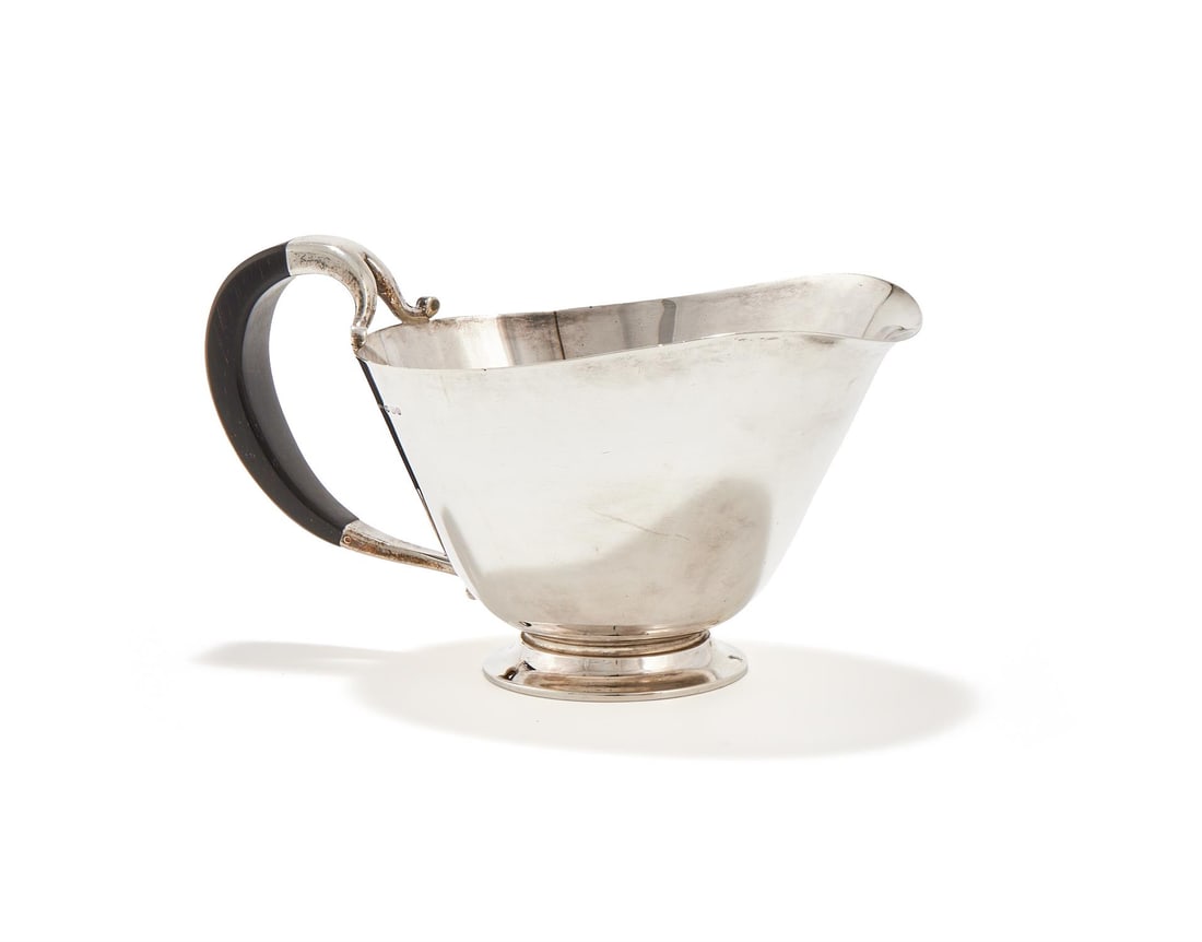 Y JORGAN JENSEN (DANISH, 1895-1966), A SAUCE BOAT, 'MODEL NO. 896', POST 1945: Y JORGAN JENSEN (DANISH, 1895-1966)A SAUCE BOAT, 'MODEL NO. 896', POST 1945Silver, ebony handleStamped maker's marks and Danish hallmarks. With London import marks dated 1955.10.5cm high, 18.5cm wide