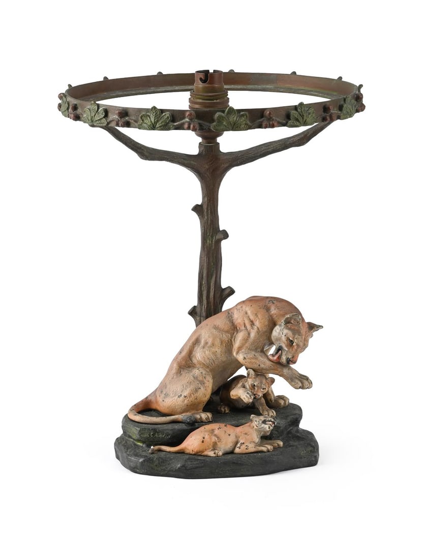 LOUIS-ALBERT CARVIN (FRENCH, 1875-1951), LION TABLE LAMP; CIRCA 1930: LOUIS-ALBERT CARVIN (FRENCH, 1875-1951)LION TABLE LAMP; CIRCA 1930Cold painted bronze; depicting a lion and two cubs, band of foliage decoration to edge of light fixtureSigned 'LCARVIN'32cm high